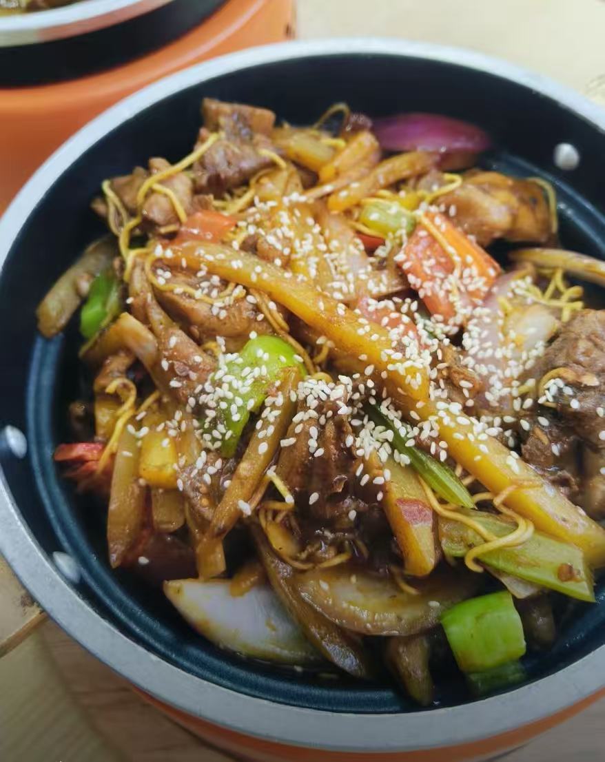 Signature spicy chicken pot with noodles and vegetables